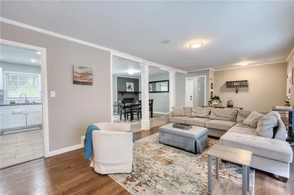 a living room with furniture and a wooden floor
