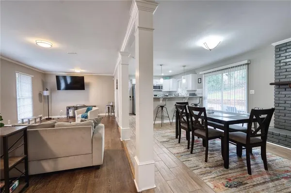 a view of a dining room with furniture and wooden floor