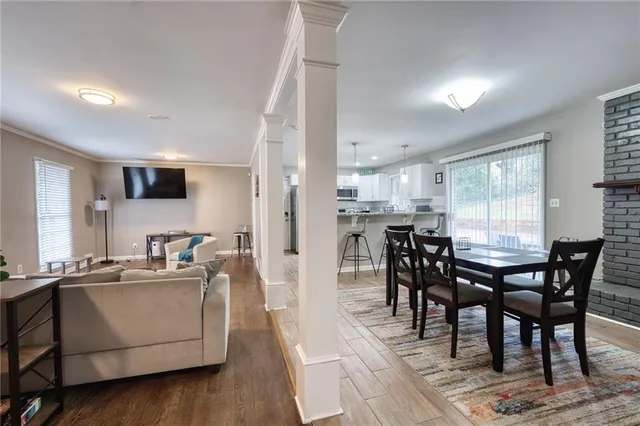 a view of a dining room with furniture and wooden floor