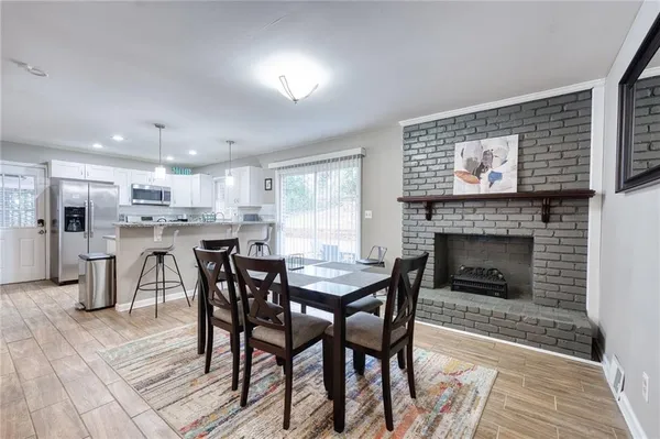 a view of a dining room with furniture and a fireplace
