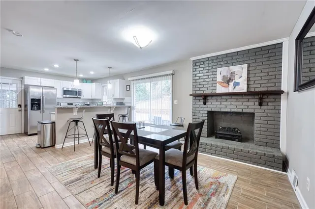 a view of a dining room with furniture and a fireplace