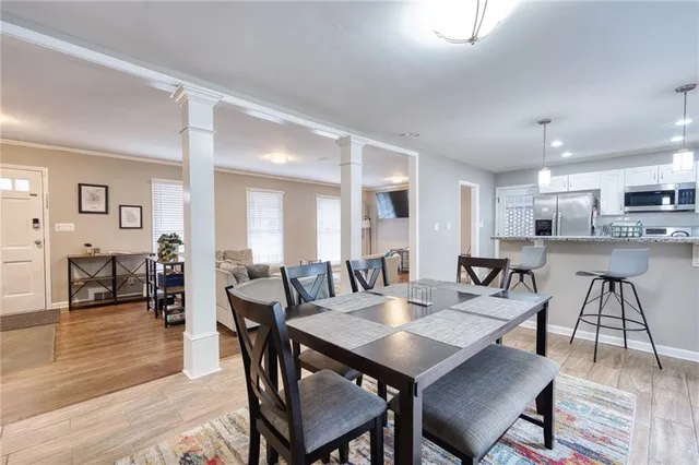 a view of a dining area with furniture and wooden floor