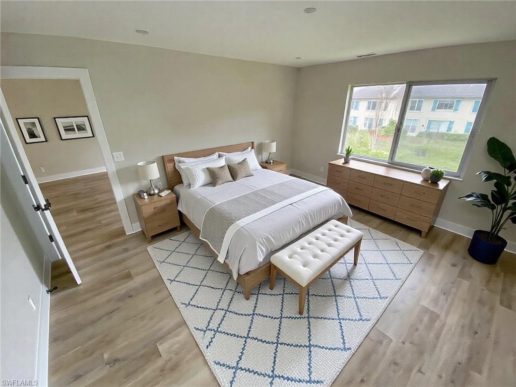 4180 Looking Glass Lane, Unit 4108 Naples, FL 34112 - Photo 8 of 21 Bedroom featuring light wood-type flooring and baseboards