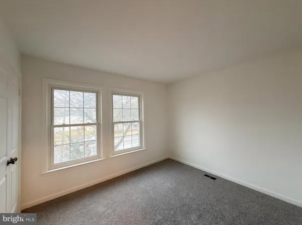 a kitchen with white cabinets sink and appliances
