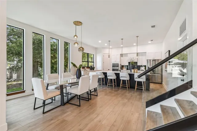 a living room with furniture dining table and a large window