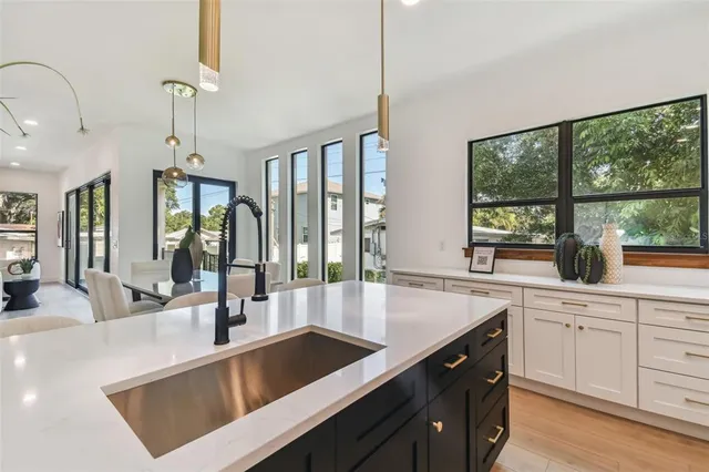 a open kitchen with a sink and large window