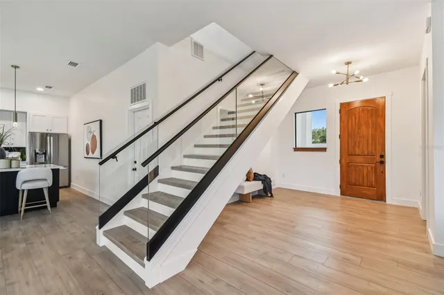 a view of entryway and hall with wooden floor