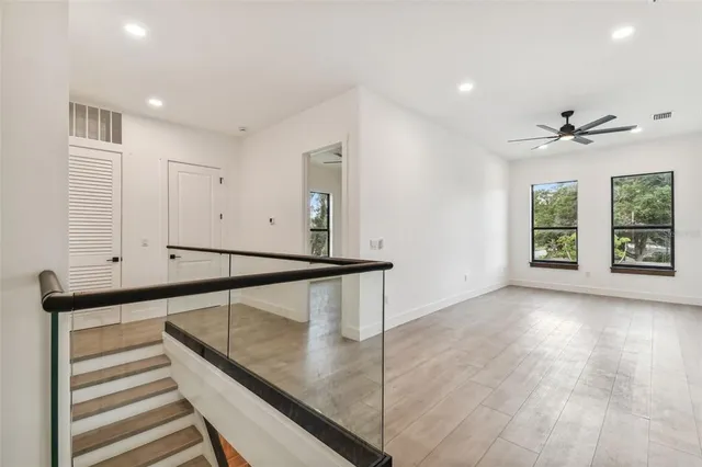 a view of entryway and hall with wooden floor