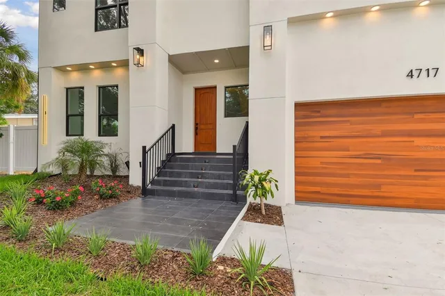 a view of a entryway door of the house with flower pots