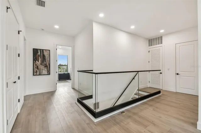 a view of a hallway with wooden floor
