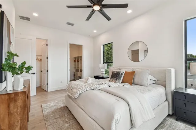 a bedroom with a bed and a chandelier