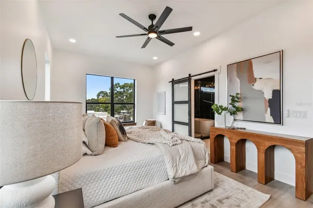 a bathroom with a bathtub a sink a window and shower