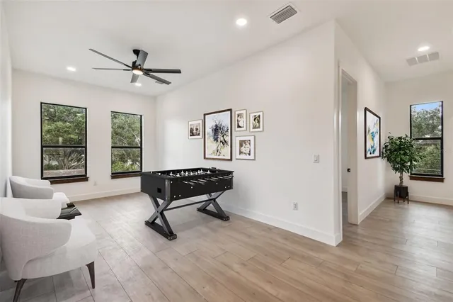 a living room with furniture ceiling fan and a window