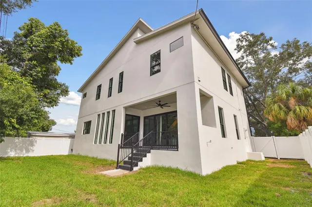 a aerial view of a house with yard and green space