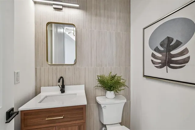 a bathroom with a toilet sink and mirror