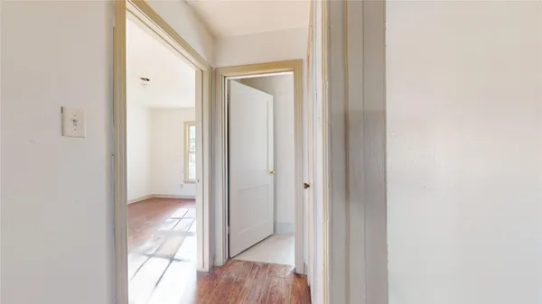 a view of a room with wooden floor