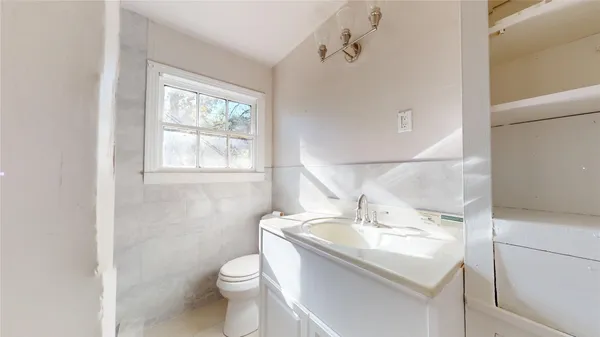 a bathroom with a sink toilet and vanity