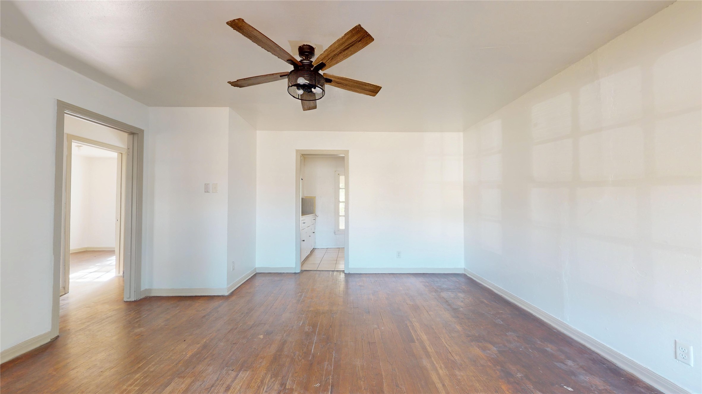 3826 Landa Lane Houston, TX 77023 - Photo 5 of 36 an empty room with wooden floor and windows