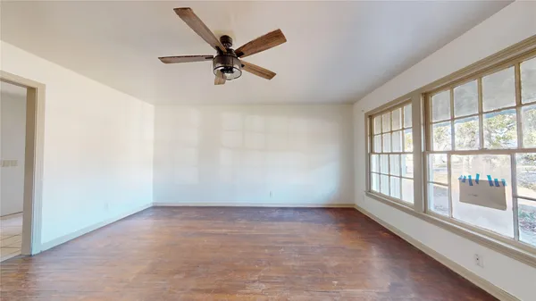 wooden floor in an empty room with a window