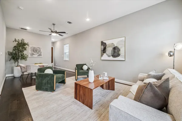 a living room with furniture and a chandelier