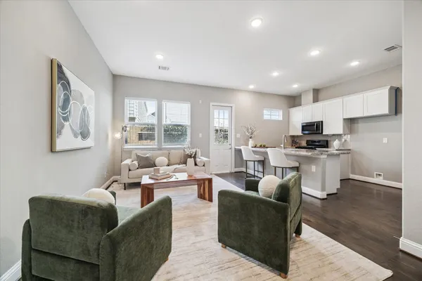 a living room with furniture and kitchen view