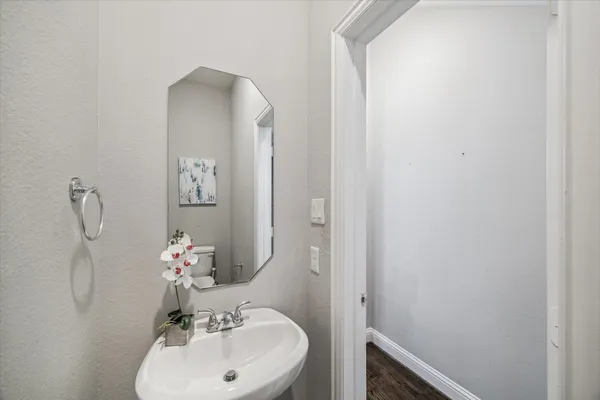 a bathroom with a sink and mirror with toilet