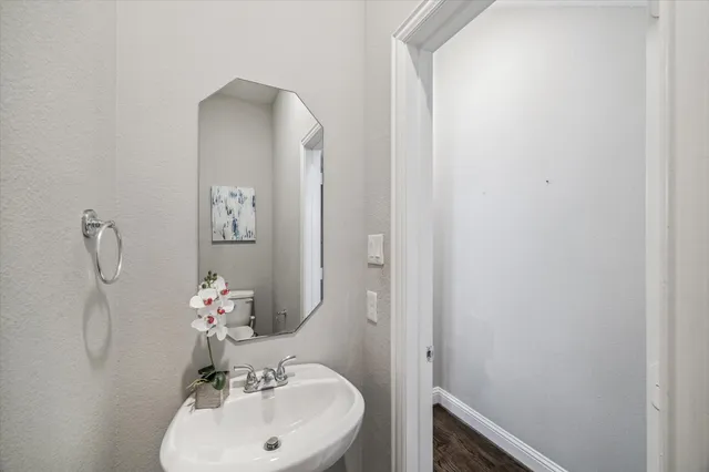 a bathroom with a sink and mirror with toilet