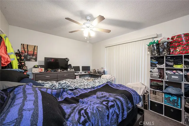 a bedroom with a bed and a book shelf