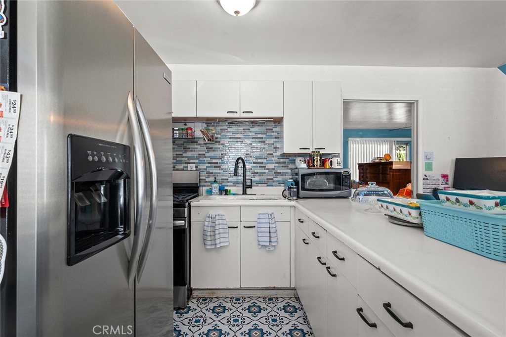 5355 Cogswell Road El Monte, CA 91732 - Photo 18 of 33 a kitchen with stainless steel appliances a refrigerator sink and cabinets