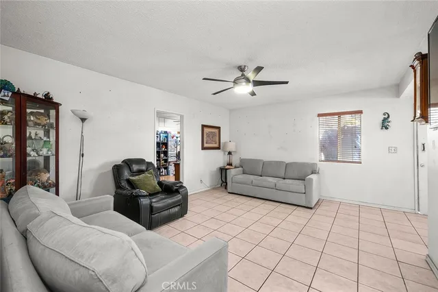 a living room with furniture and a view of kitchen