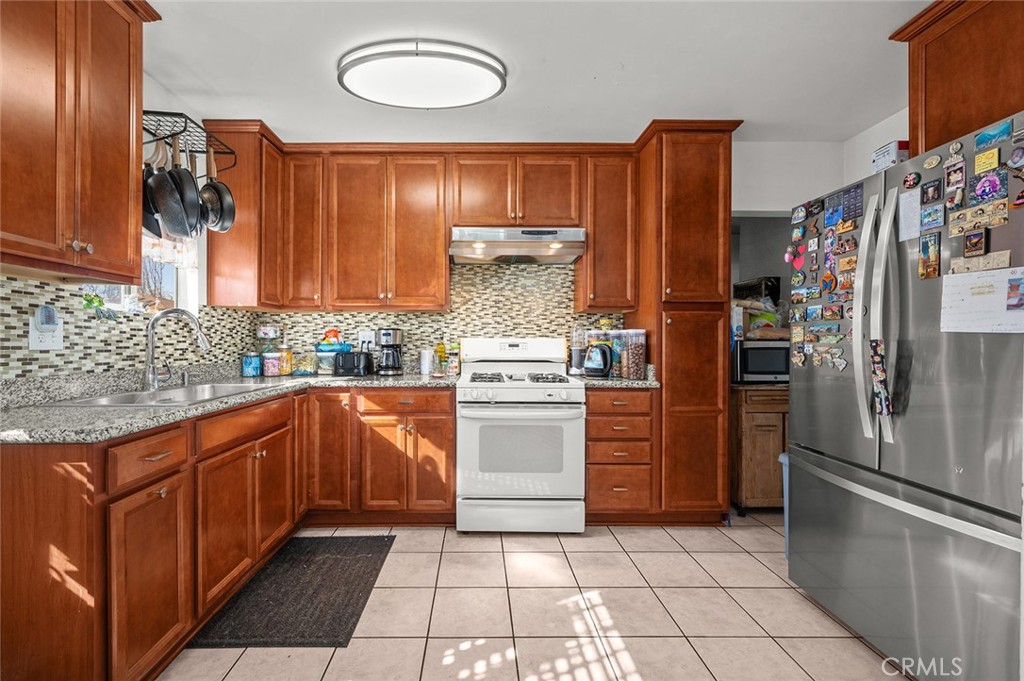 5355 Cogswell Road El Monte, CA 91732 - Photo 7 of 33 a kitchen with stainless steel appliances granite countertop a refrigerator and a sink