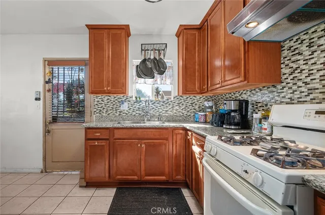a kitchen with stainless steel appliances a stove a sink and a microwave