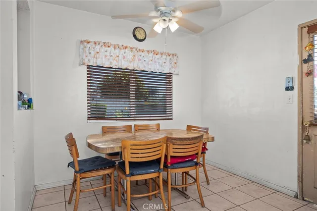 a dining room with furniture and a window