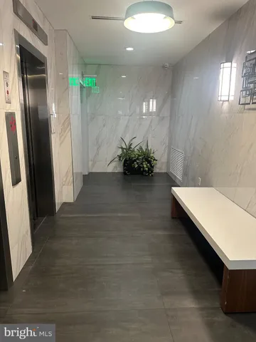 view of a room with floor to ceiling window and stairs