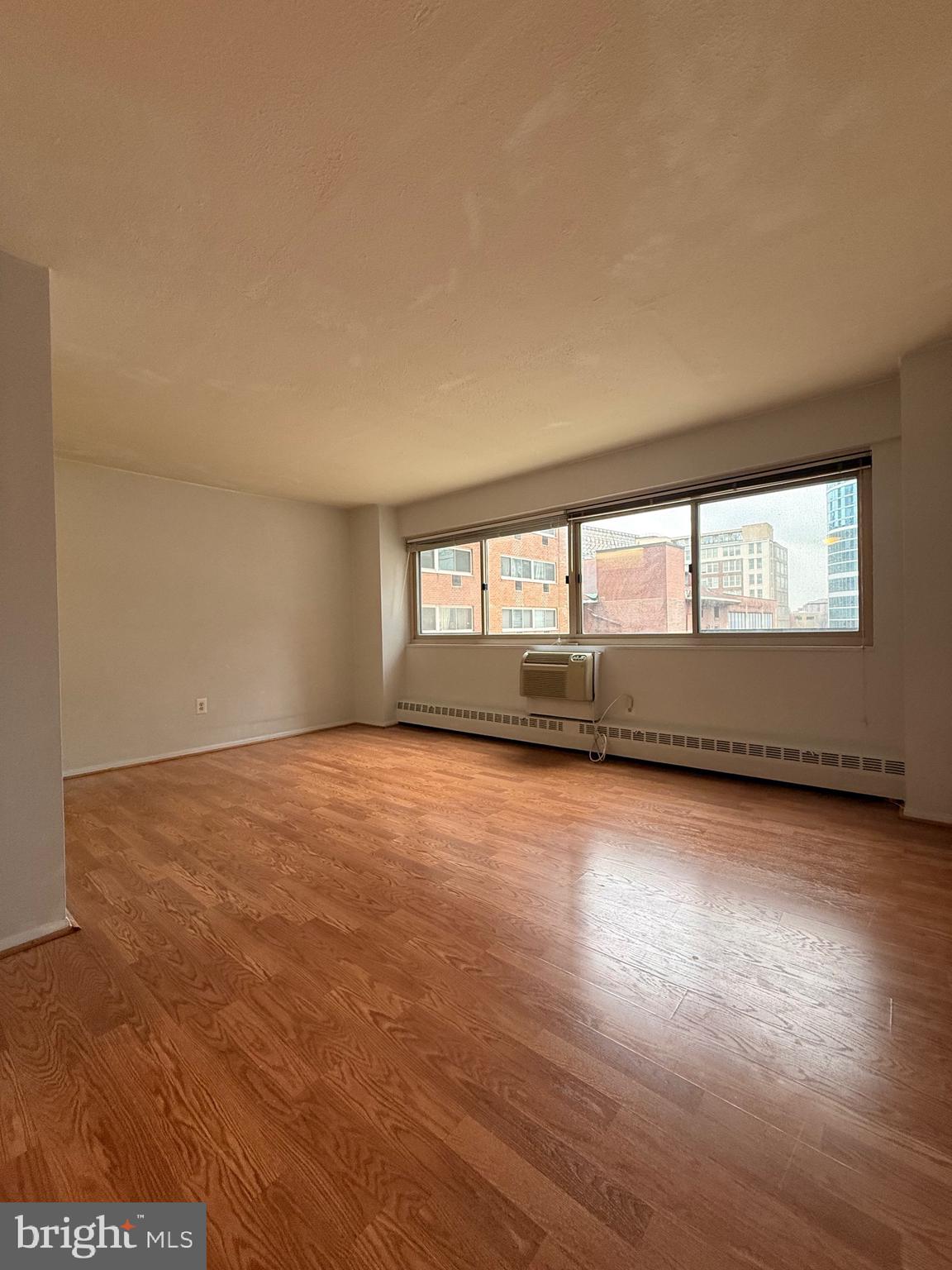 2101-17 Chestnut Street, Unit 424 Philadelphia, PA 19103 - Photo 4 of 14 an empty room with wooden floor and windows