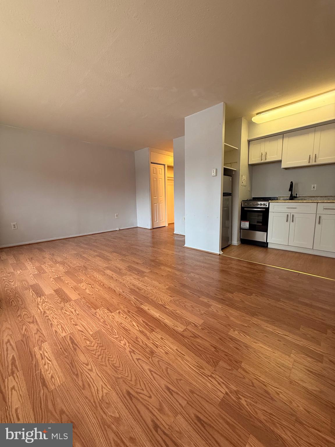 2101-17 Chestnut Street, Unit 424 Philadelphia, PA 19103 - Photo 5 of 14 a view of an empty room with window and wooden floor