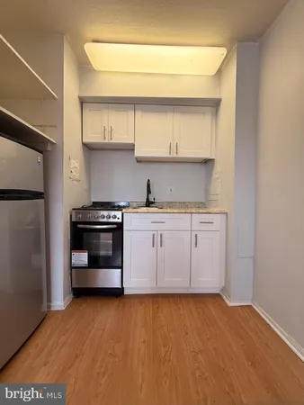 a kitchen with a sink cabinets and stainless steel appliances