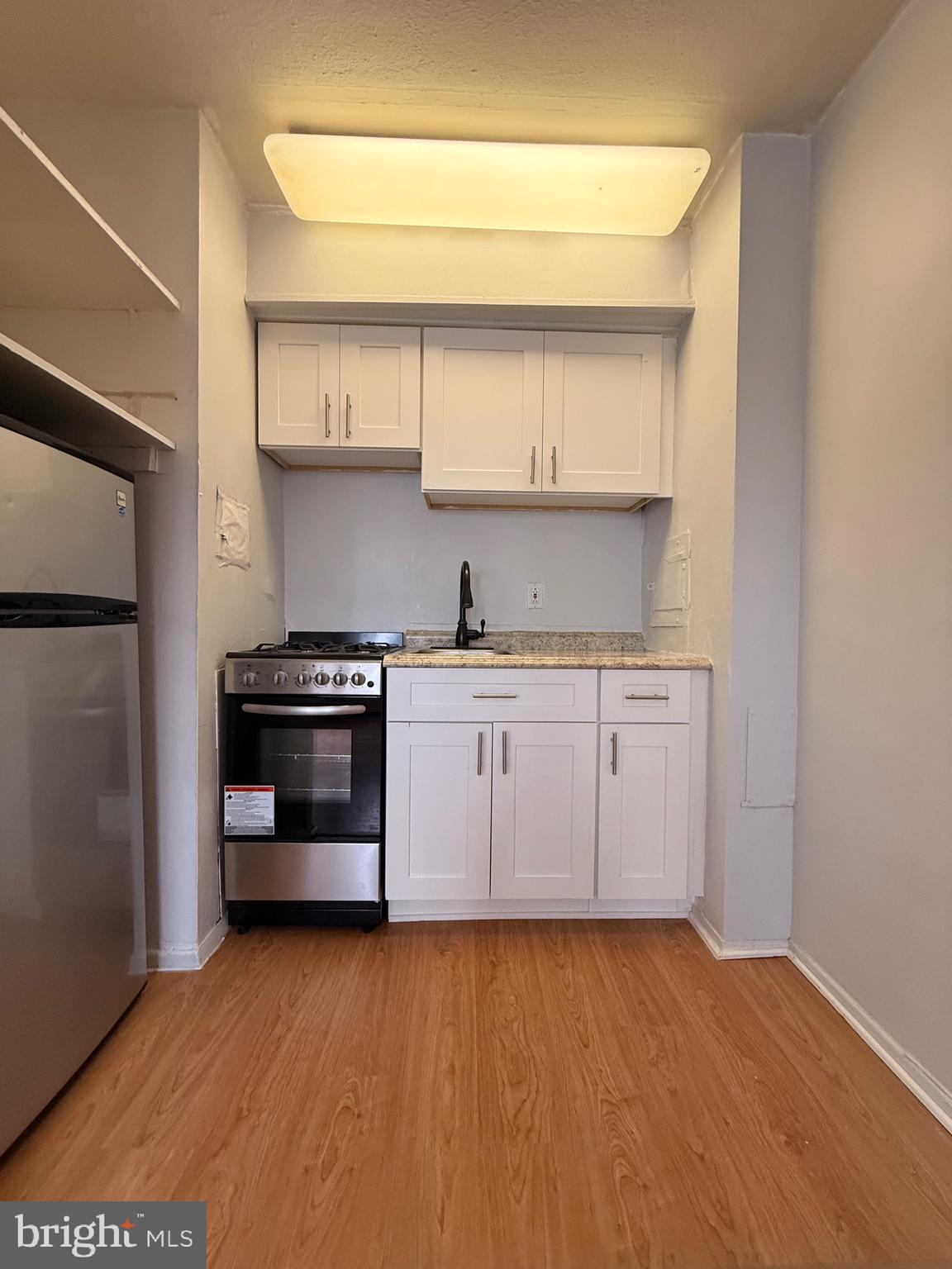2101-17 Chestnut Street, Unit 424 Philadelphia, PA 19103 - Photo 6 of 14 a kitchen with a sink cabinets and stainless steel appliances