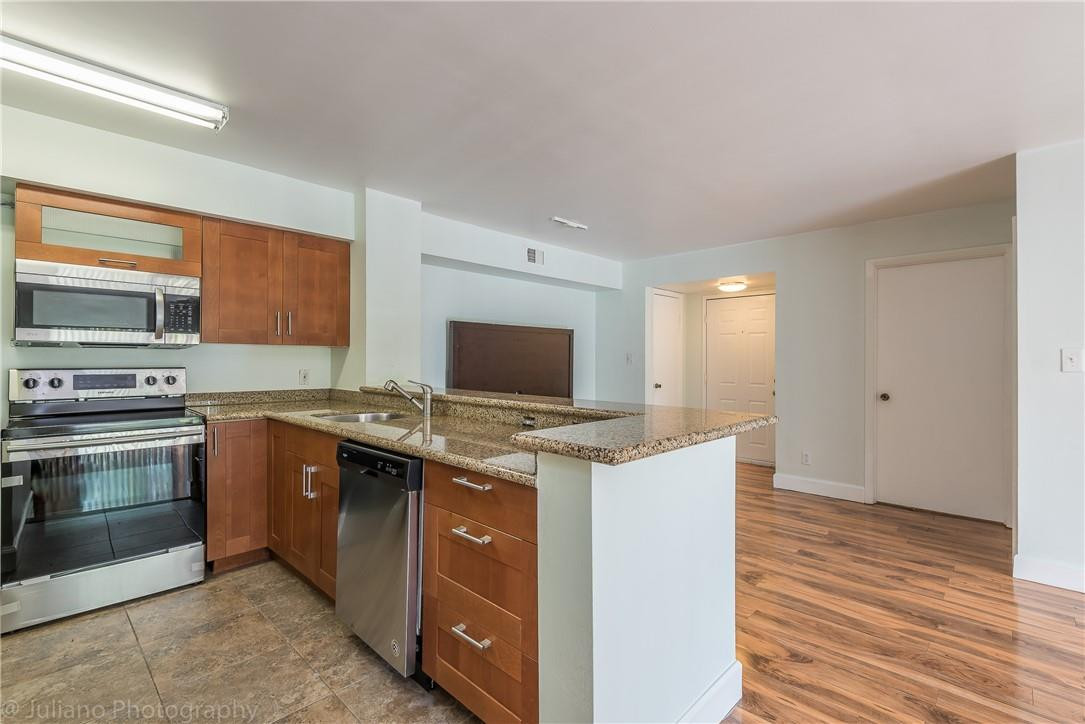 560 South Park Road, Unit 247 Hollywood, FL 33021 - Photo 5 of 21 a kitchen with a stove and a microwave