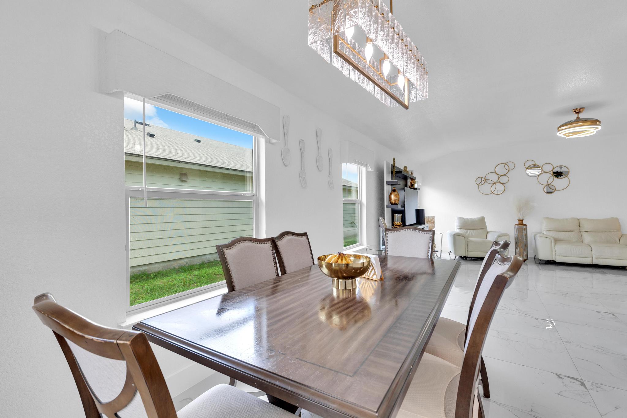 119 Beth Ann Loop Taylor, TX 76574 - Photo 14 of 31 Illuminated by natural light, this dining area features a stylish rectangular table paired with elegant seating.