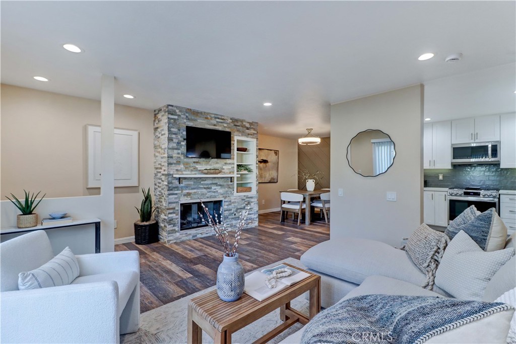 a living room with furniture a fireplace and a flat screen tv