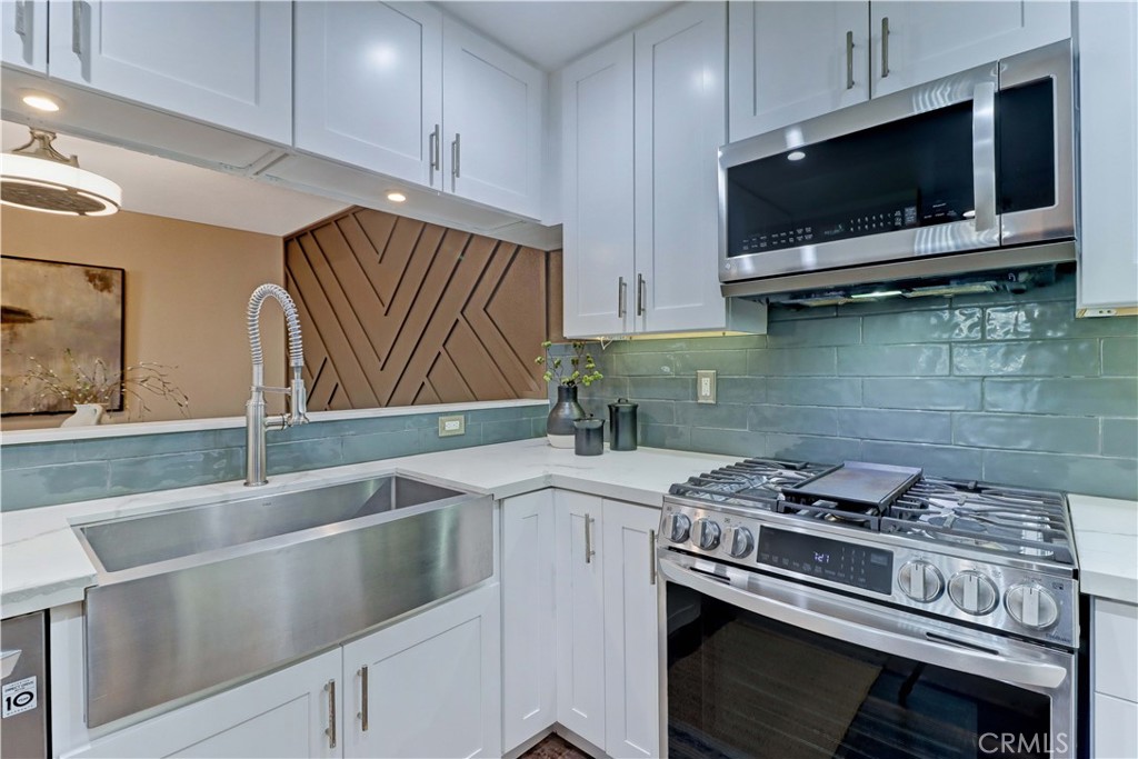 3605 East Anaheim Street, Unit 102 Long Beach, CA 90804 - Photo 12 of 37 a kitchen with a stove and a microwave