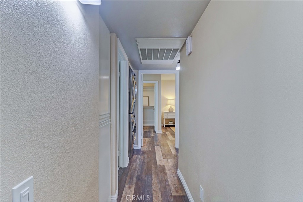 3605 East Anaheim Street, Unit 102 Long Beach, CA 90804 - Photo 16 of 37 a view of a hallway with wooden floor and a bathroom
