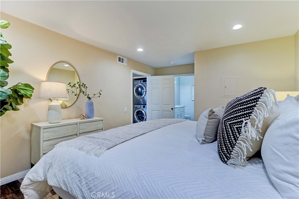 3605 East Anaheim Street, Unit 102 Long Beach, CA 90804 - Photo 23 of 37 a bedroom with a bed and a chandelier