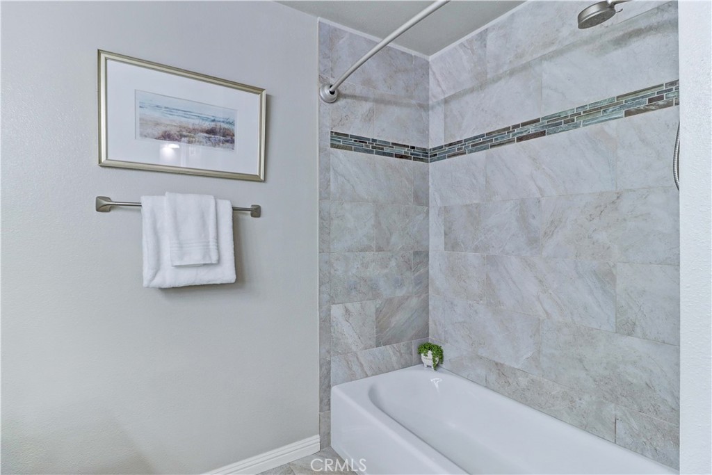 3605 East Anaheim Street, Unit 102 Long Beach, CA 90804 - Photo 29 of 37 a bathroom with a shower and a tub