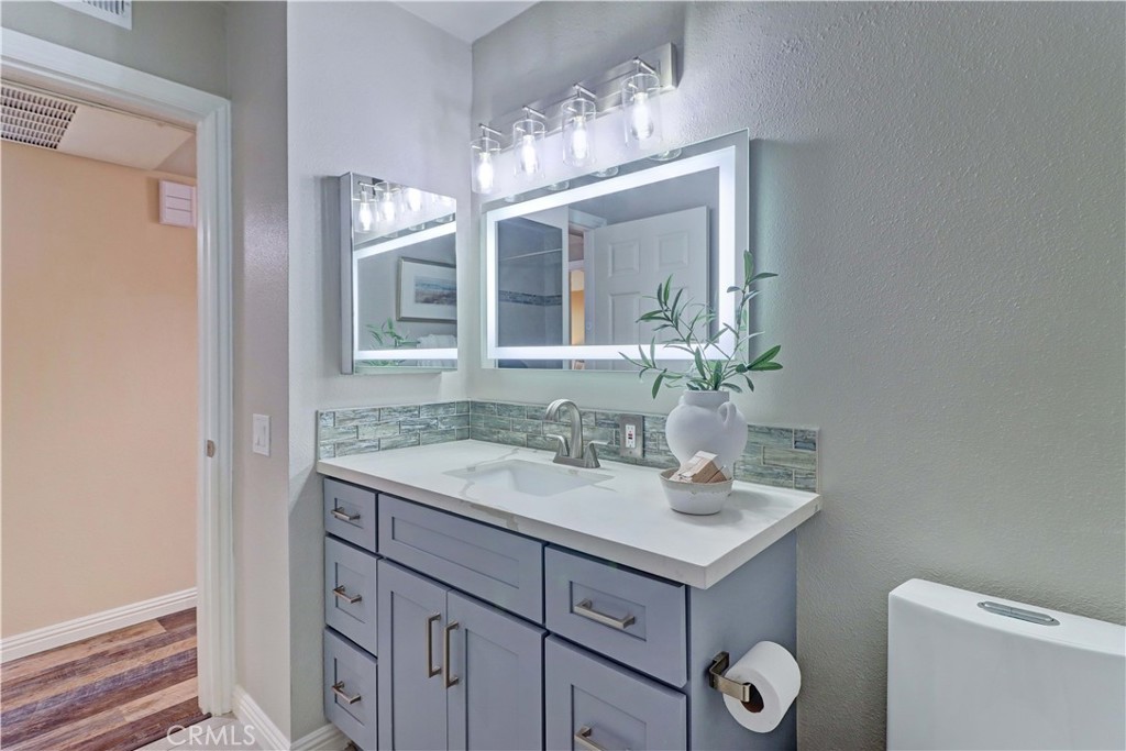 3605 East Anaheim Street, Unit 102 Long Beach, CA 90804 - Photo 30 of 37 a bathroom with a sink and a mirror