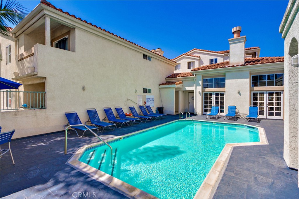 3605 East Anaheim Street, Unit 102 Long Beach, CA 90804 - Photo 37 of 37 a view of a house with pool and chairs