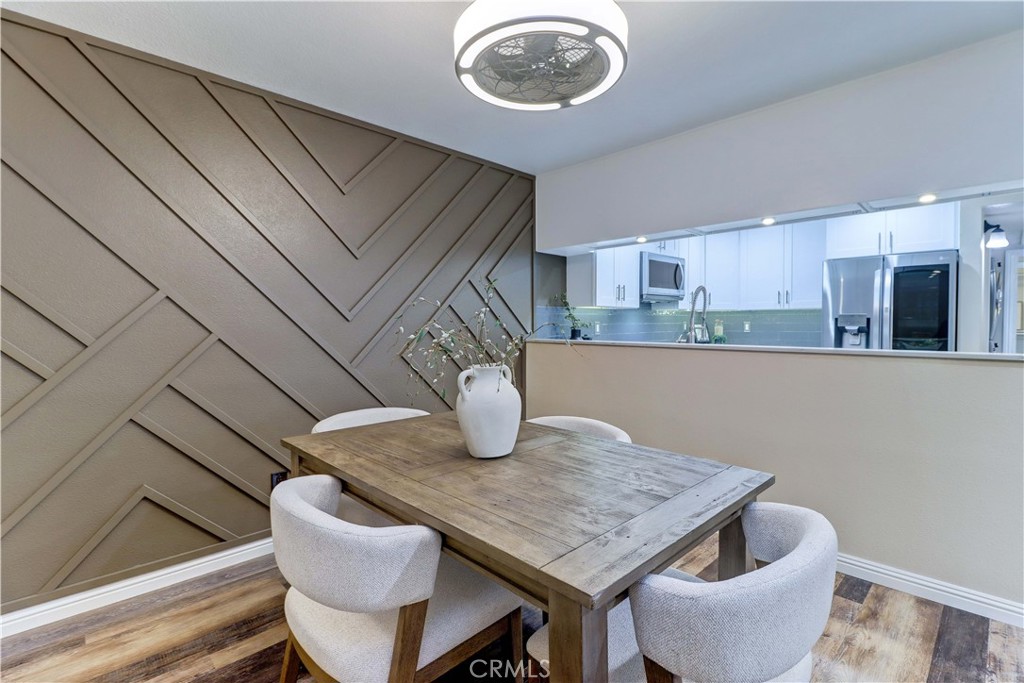 3605 East Anaheim Street, Unit 102 Long Beach, CA 90804 - Photo 8 of 37 a kitchen with a table and chairs