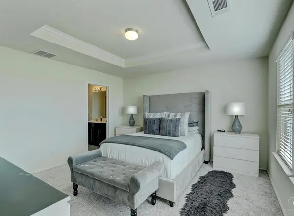 a bedroom with a bed and a couch