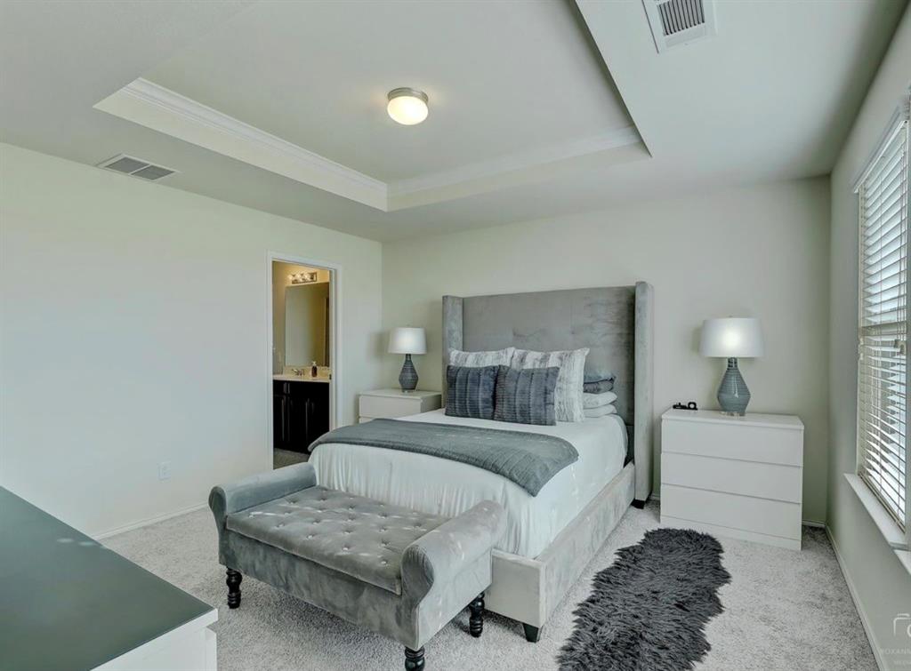 2207 Heaton Street Forney, TX 75126 - Photo 14 of 25 a bedroom with a bed and a couch